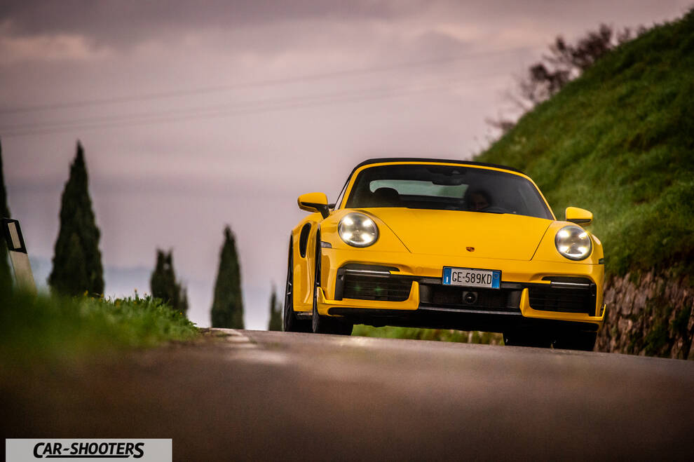 Porsche 911 Turbo Cabrio – front three-quarter, yellow on a country road