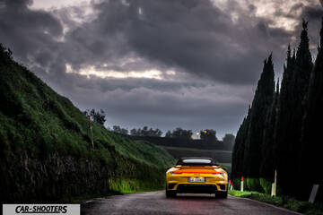 Porsche 911 Turbo Cabrio – rear view, yellow on a country road