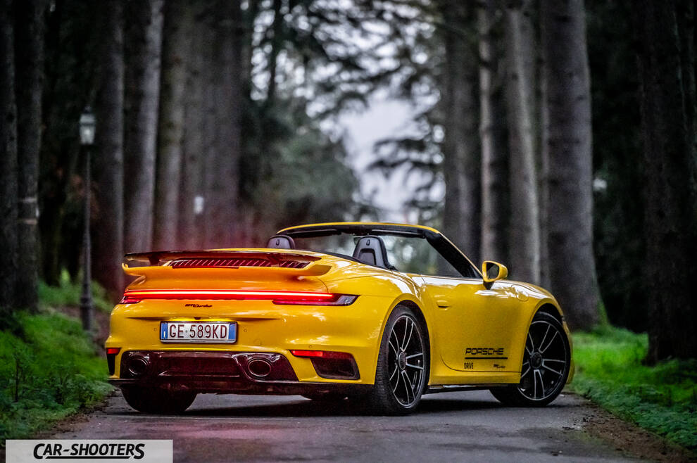 Porsche 911 Turbo Cabrio – rear three-quarter, yellow on a forest road