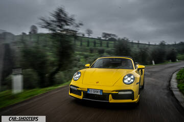 Porsche 911 Turbo Cabrio – front three-quarter, yellow on a country road