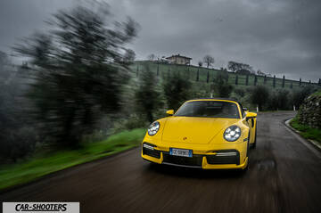 Porsche 911 Turbo Cabrio – front three-quarter, yellow on a country road