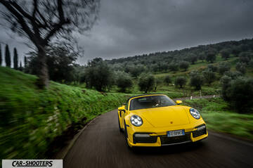 Porsche 911 Turbo Cabrio – front three-quarter, yellow on a country road