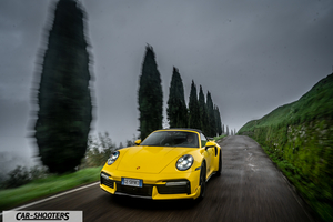 Porsche 911 Turbo Cabrio – front three-quarter, yellow on a country road