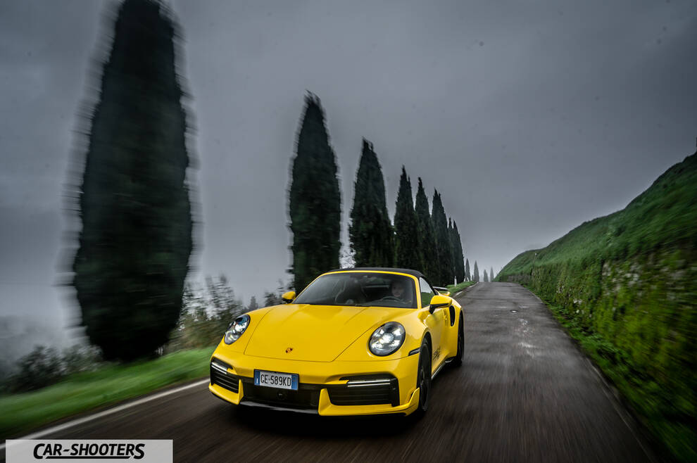 Porsche 911 Turbo Cabrio – front three-quarter, yellow on a country road