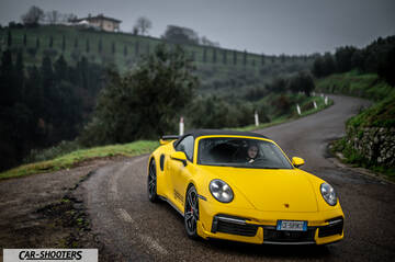 Porsche 911 Turbo Cabrio – front three-quarter, yellow on a country road