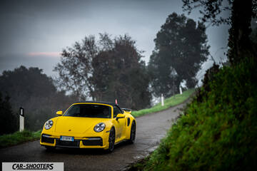 Porsche 911 Turbo Cabrio – front three-quarter, yellow on a country road