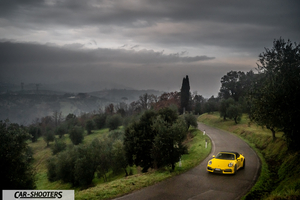 Porsche 911 Turbo Cabrio – front three-quarter, yellow on a country road