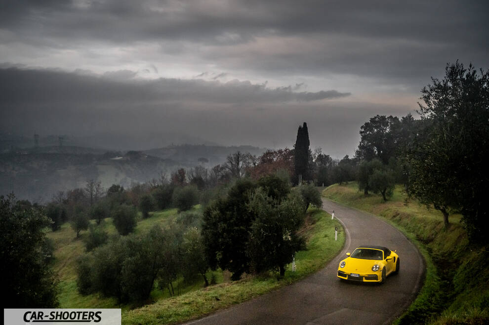 Porsche 911 Turbo Cabrio – front three-quarter, yellow on a country road