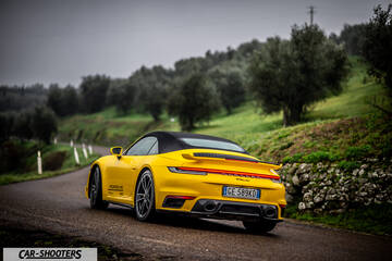 Porsche 911 Turbo Cabrio – rear three-quarter, yellow on a country road