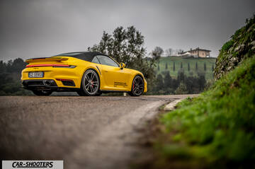 Porsche 911 Turbo Cabrio – rear three-quarter, yellow on a country road