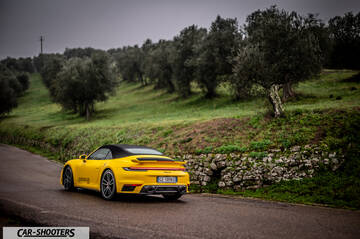 Porsche 911 Turbo Cabrio – rear three-quarter, yellow on a country road