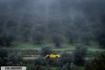 Porsche 911 Turbo Cabrio – side profile, yellow on a country road