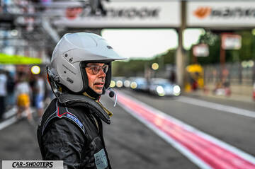 detail, driver wearing helmet in pit lane
