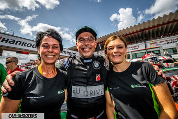 detail, three people smiling at a racetrack