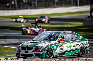 front three-quarter, white and green on a race track