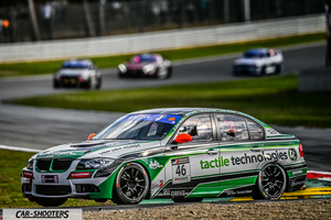 front three-quarter, green and white on a race track