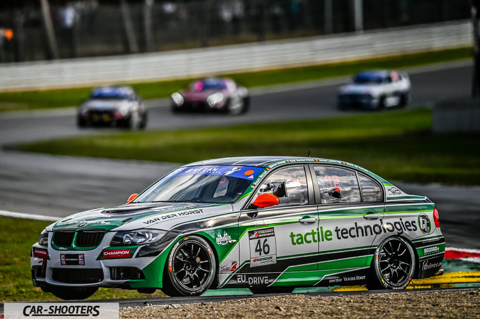front three-quarter, green and white on a race track