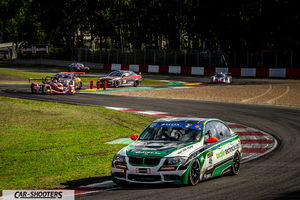 front three-quarter, white and green on a race track