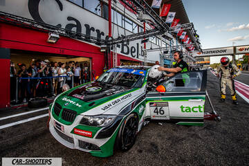 front three-quarter, white with green and black livery in a pit lane