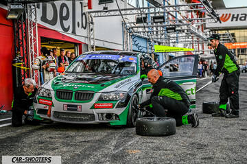 front three-quarter, white with green and black livery in a pit lane during a pit stop
