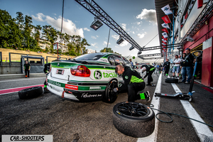 rear three-quarter, white with green and black livery in a pit lane during a pit stop