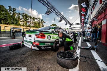 rear three-quarter, white with green and black livery in a pit lane during a pit stop