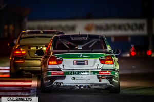 rear view, white on a race track at night