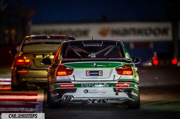 rear view, white on a race track at night