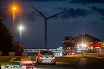 rear view, white on a racetrack at night