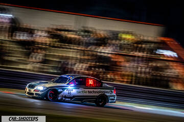 front three-quarter, silver on a race track at night