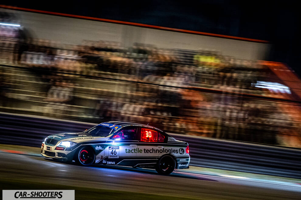 front three-quarter, silver on a race track at night