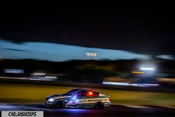 side profile, white on a race track at night