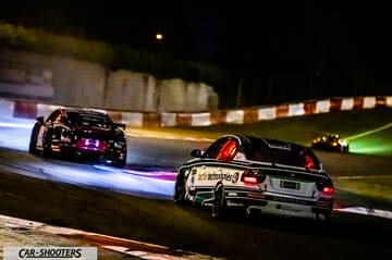 rear three-quarter, white on a race track at night