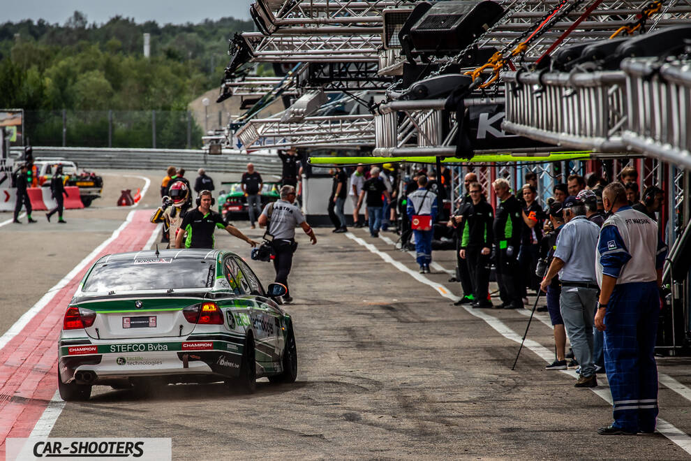 rear three-quarter, white with green on a race track pit lane