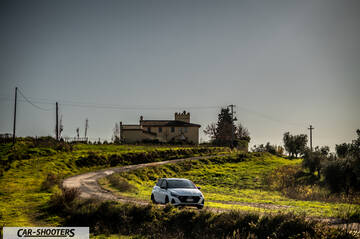 Hyundai i2N – front three-quarter, white on a country road