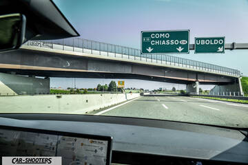 Tesla Model S Plaid – dashboard, on a highway approaching an overpass