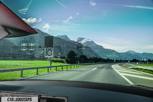 Tesla Model S Plaid – dashboard, view from inside against a mountain backdrop