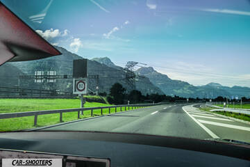Tesla Model S Plaid – dashboard, view from inside against a mountain backdrop