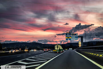 Tesla Model S Plaid – rear view, on a highway at sunset