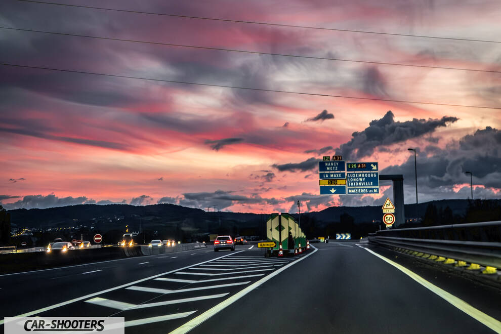 Tesla Model S Plaid – rear view, on a highway at sunset