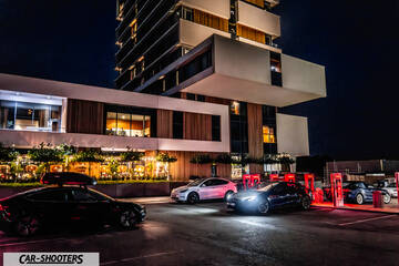Tesla Model S Plaid – front three-quarter, black at a charging station at night