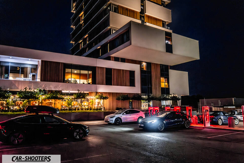 Tesla Model S Plaid – front three-quarter, black at a charging station at night