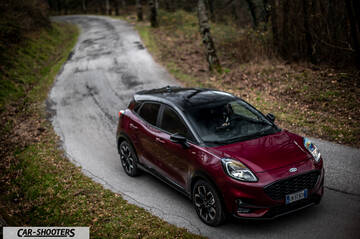 Ford Puma STLine – front three-quarter, dark red metallic on a winding country road