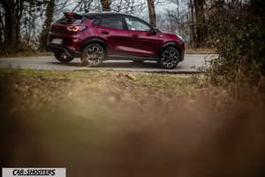 Ford Puma STLine – rear three-quarter, dark red metallic on a country road