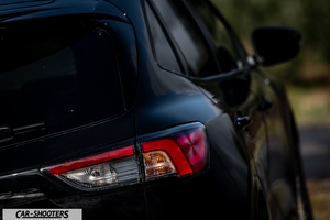 Ford Kuga STLine – rear three-quarter, black against a blurred outdoor background