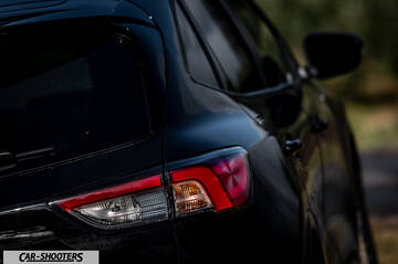 Ford Kuga STLine – rear three-quarter, black against a blurred outdoor background