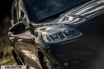Ford Kuga STLine – front three-quarter, dark grey against a blurred natural background