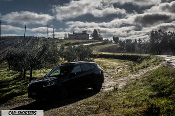 Ford Kuga STLine – front three-quarter, black on a country road