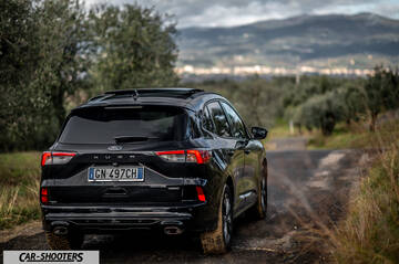 Ford Kuga STLine – rear three-quarter, black on a country road