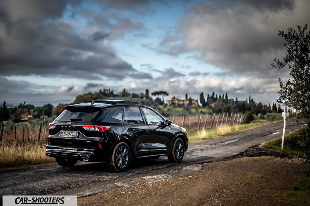 Ford Kuga STLine – rear three-quarter, black on a country road
